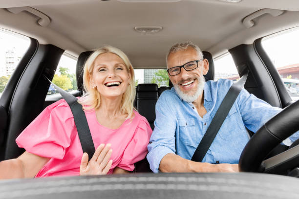 istock Happy elderly couple have car ride, taking selfie 1854456191