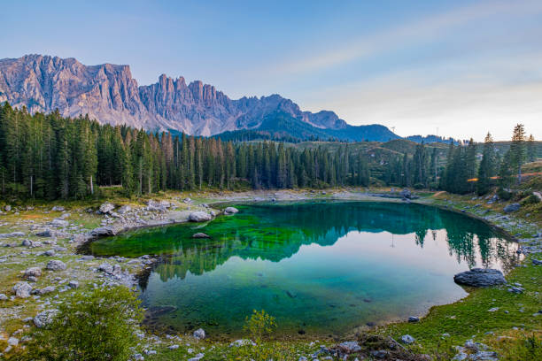 istock Emerald waters, misty Spruce forests, and breathtaking views define Lago di Carezza, an alpine favourite in Val d'Ega, South Tyrol, and the Dolomites. Beyond its 'insta-worthy' fame, it holds a special place in our hearts 1854460009