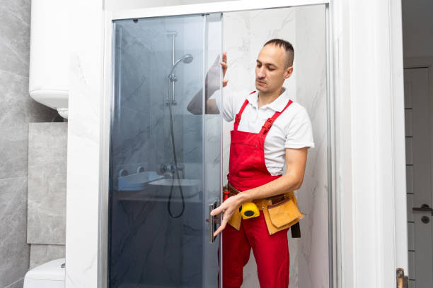 istock Plumber installing a shower cabin in bathroom 1854463782