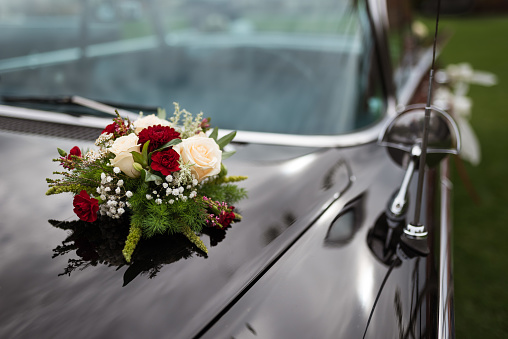 A bouquet of flowers on a stylish limousine