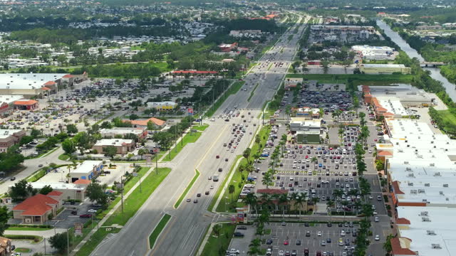 Wide highway with shopping malls and small businesses in North Port, Florida. USA transportation and retail infrastructure concept