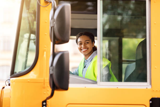 istock Happy Black School Bus Female Driver Smiling At Camera Through Open Window 1854475512