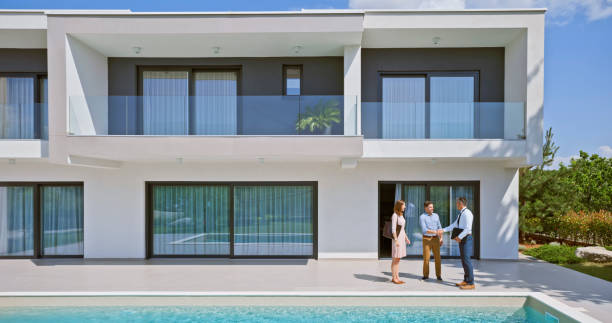 istock Male estate agent shaking hand with man 1854477128