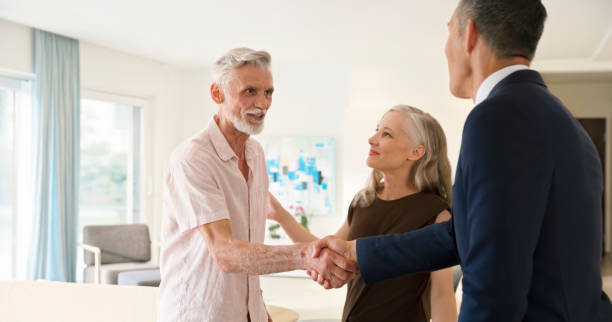 istock Male estate agent shaking hand with man 1854477143