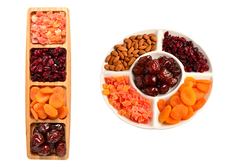 Mix of dried fruits and nuts. Apricot, raisin, cranberry, dates fruit. Isolated on a white background. Space for text or design.