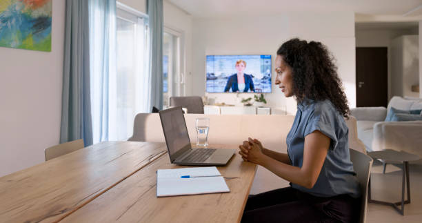 istock Woman using laptop at home 1854478357