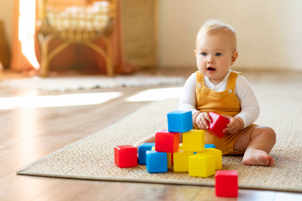 istock Adorable Infant Baby Playing With Stacking Building Blocks At Home 1854482682