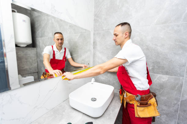 istock Man installing a mirror on wall in his renewed bathroom 1854486046