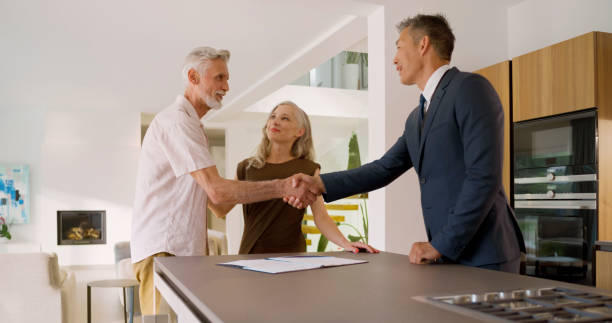 istock Male estate agent shaking hands with man 1854487947