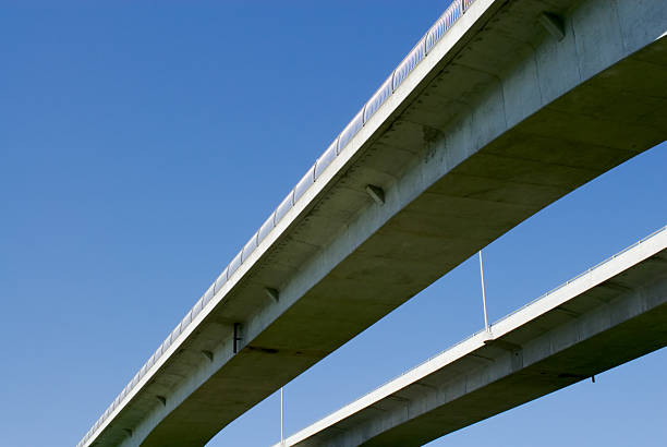 istock Pair of highway bridges on blue sky 185449469