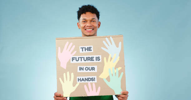 istock Man, protest poster and studio portrait for accountability to stop climate change by blue background. Happy volunteer person, social responsibility and vision for future, sustainability and ecology 1854495398