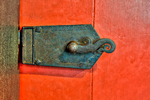 Old ornate metal lock on red door stock photo