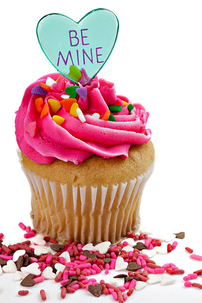 Valentine cupcake with pink frosting and heart stock photo