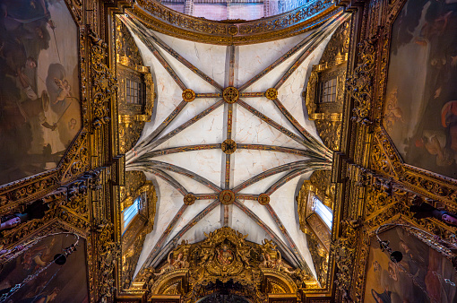 Marble ceiling with golden beams decorated with floral motifs of the baroque chapel carved in wood with saints and Jesus Christ with religious paintings on the sides of the convent of San Francisco.