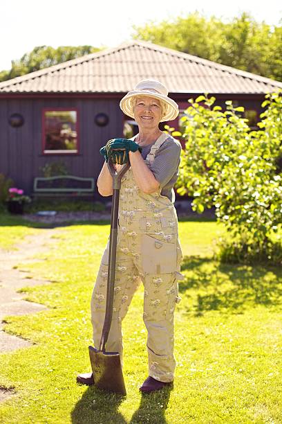 istock Active senior woman with gardening tools 185450291