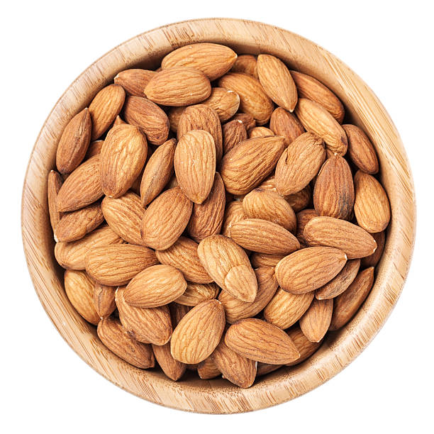 istock Almonds in a brown wooden bowl isolated on white background 185450809