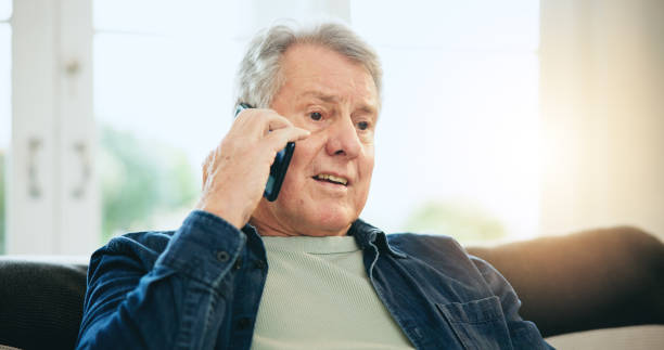 istock Home, phone call and senior man with conversation, network and speaking with discussion. Apartment, elderly person and pensioner with a smartphone, relax and communication with digital app and idea 1854509116