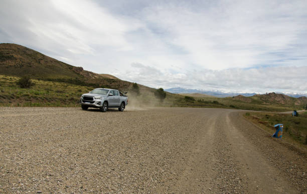 istock truck approaching on a dirt and mountain road 1854511288