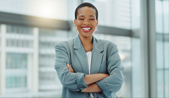 Portrait, business woman and smile with arms crossed for pride, confidence and working in human resources agency in Nigeria. Happy african employee, HR manager or expert staff in professional company