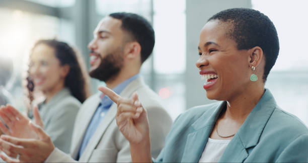 istock Business woman, laughing and applause at conference, workshop or convention with work audience. Crowd, employees and company workers with clapping for achievement of group together for presentation 1854516733