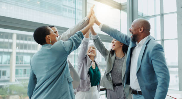 istock Celebration, business people and high five at a conference with teamwork and motivation in office. Discussion, staff and collaboration with professional team at a seminar with workforce and agreement 1854517252