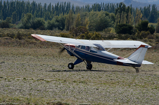 light propeller plane taking off or landing. on dirt track