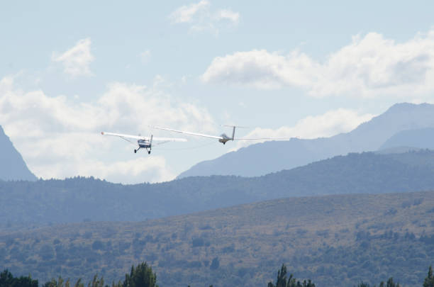 istock ultralight glider towed by propeller plane 1854535584