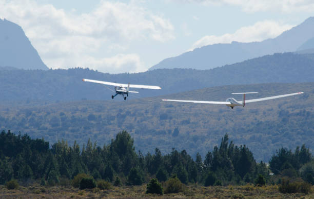 istock ultralight glider towed by propeller plane 1854535586