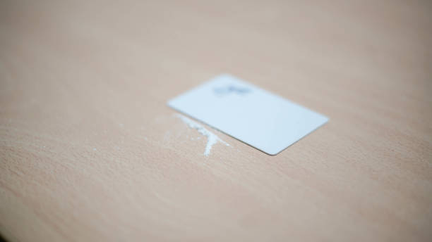 istock Cocaine stripe on a table with a card next to it 1854541189