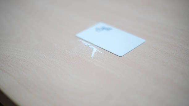 istock Cocaine stripe on a table with a card next to it 1854541197
