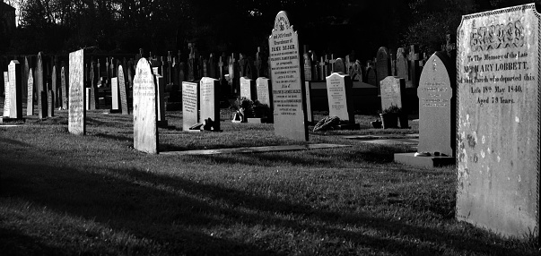 Crow Agency, MT, USA - June 23, 2022: Tourist visit Little Bighorn Battlefield, National Monument. Pictured here, tombstones of Custer National Cemetery. \n\nLittle Bighorn Battlefield, National Monument memorializes the US Army's 7th Cavalry and the Lakotas andnd Cheyennes in one of the Indian's last armed efforts to preserve their way of life. Here on June 25 and 26 of 1876, 263 soldiers, including Lt. Col. George A. Custer and attached personnel of the US Army, died fighting several thousand Lakota and Cheyenne warriors.