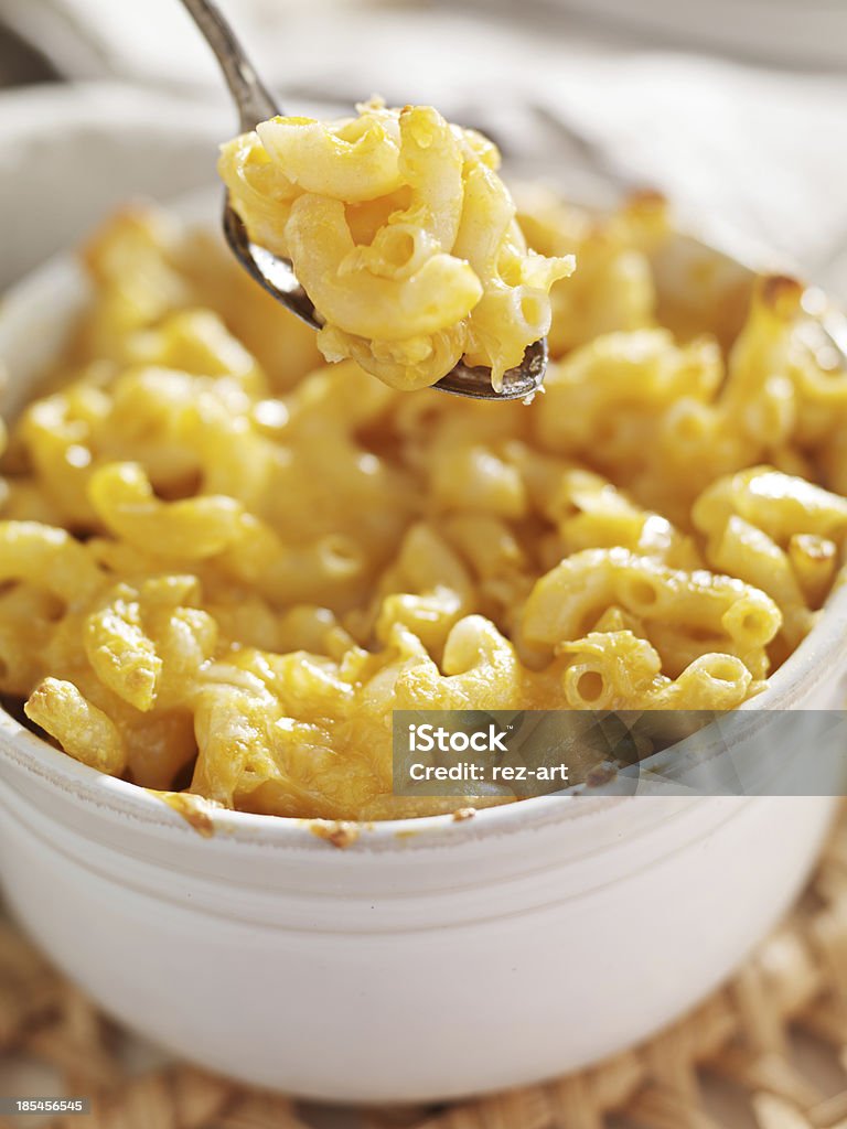 spoon picking up macaroni and cheese close up photo of a spoon picking up macaroni and cheese Bowl Stock Photo