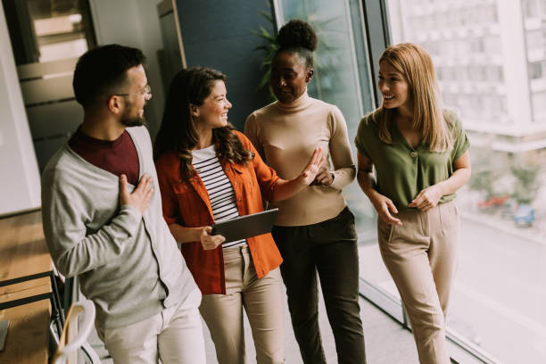 istock Young multiethnic startup team walking in the modern office 1854582594