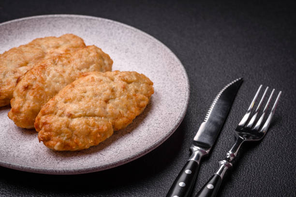 istock Delicious fresh fried minced fish or chicken cutlets with spices and herbs 1854583156