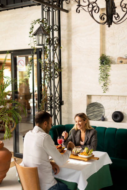 istock Young couple having lunch and drinking fresh squeezed juice in the restaurant 1854583696