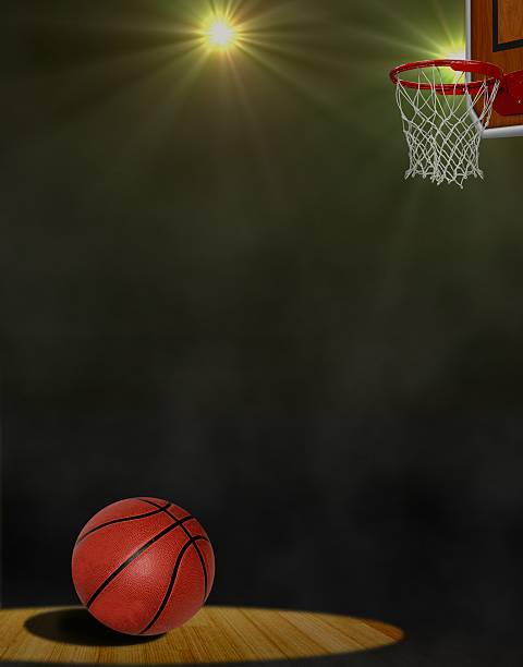 istock Basketball on the Floor and Hoop under Spotlights 185458611