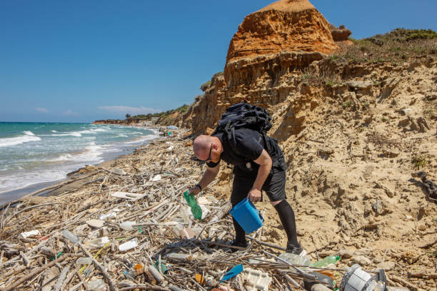 istock Male environmentalist cleaning an Italian beach 1854586979