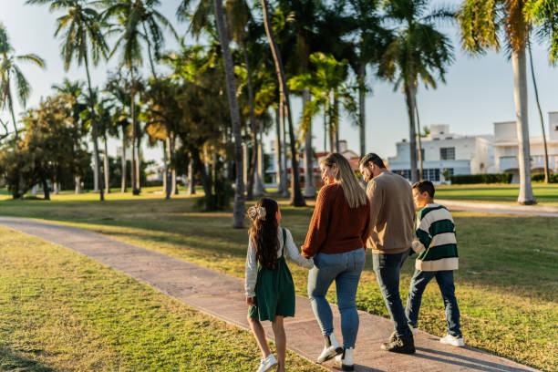 istock Family walking through the public park 1854607033