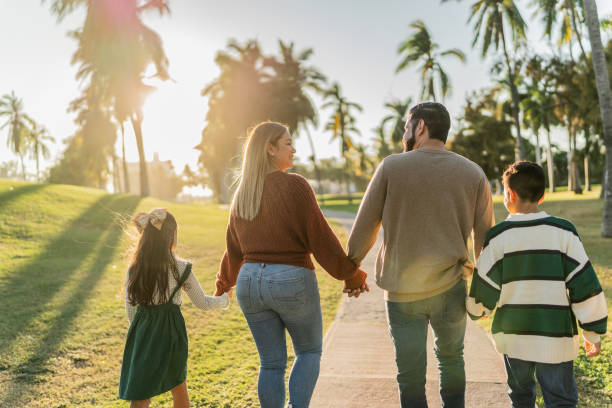 istock Family talking while walking through the public park 1854610917