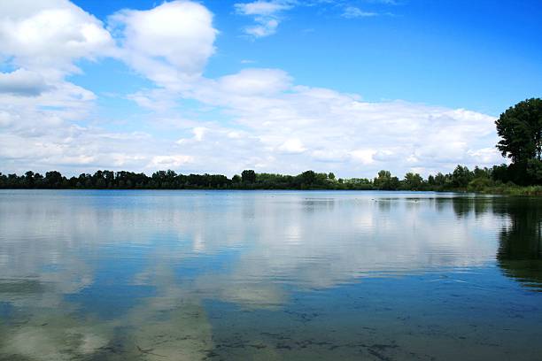 clouds over the lake a quarry pond in Germany leopoldshafen stock pictures, royalty-free photos & images