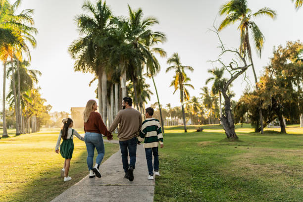 istock Family talking while walking through the public park 1854611283