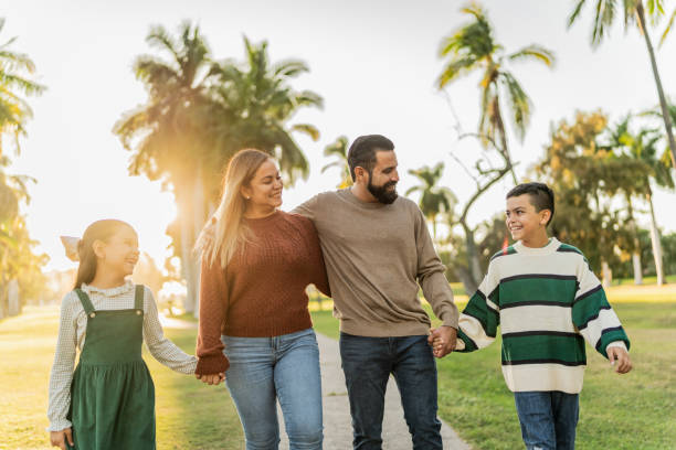 istock Family talking while walking through the public park 1854611296