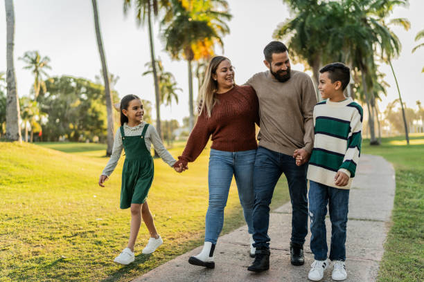 istock Family talking while walking through the public park 1854611299
