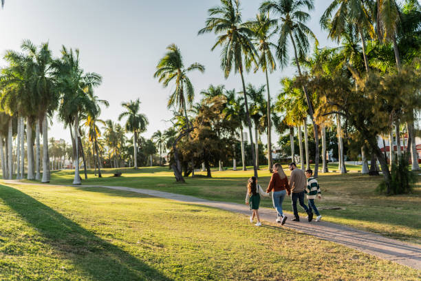 istock Family walking through the public park 1854611302