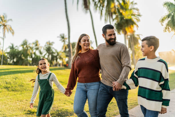 istock Family talking while walking through the public park 1854611305