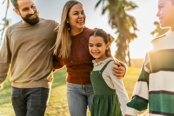 istock Family talking while walking through the public park 1854612909