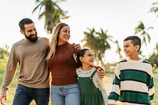 istock Family talking while walking through the public park 1854612924