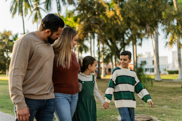 istock Family talking while walking through the public park 1854612925