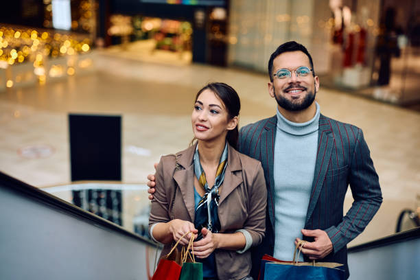 istock Young couple spending a day in shopping at the mall. 1854613436