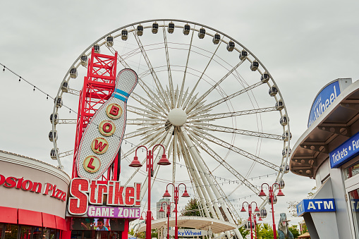 Niagara Falls, Ontario, Canada. A Photo of the Sky Wheel and the illuminated sign bowling pin shaped like a bowling pin of the bowling center named Strike Game Zone in Clifton Hill.